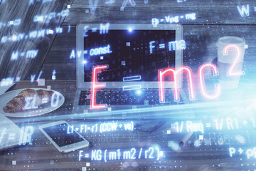 Desktop computer background and formula hologram writing. Double exposure. Education concept.