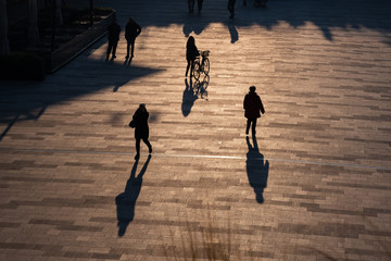 CityLife Business, Shopping and residential area in Milan, Italy. People walking in backlight.