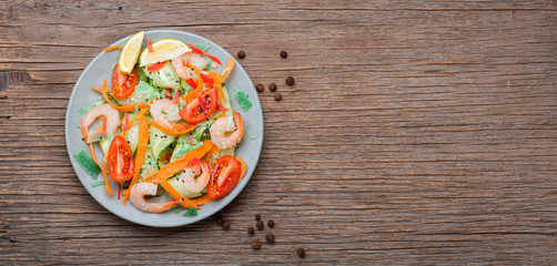 Shrimp salad on wooden table