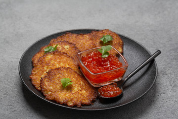 Crispy potato pancakes with red caviar. Potato pancakes fried in butter. Stack of potato fritters 