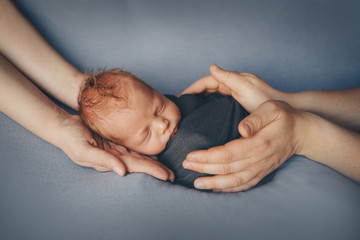 Newborn baby lying on hands of parents. Imitation of baby in womb. beautiful little girl sleeping on her back. manifestation of love. Health care concept, parenthood, children's Day, medicine, IVF