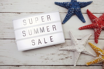 Summer sale text in light box and colorful starfish decoration