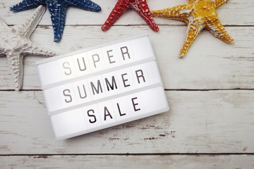 Summer sale text in light box and colorful starfish decoration