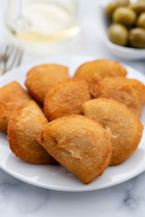 typical portuguese snack with meat rissois de carne on ceramic background