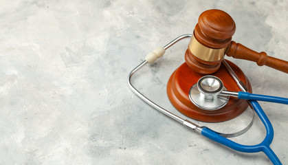 Judge gavel and stethoscope. The law in medicine, the sentence on medical negligence