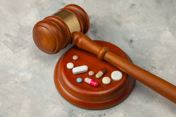 Judge gavel and pills. Law in medicine, prohibition of medicines