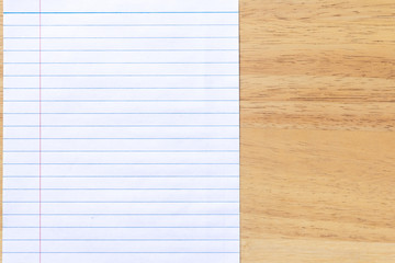 Obraz premium Blank line paper notebook on wood desk 