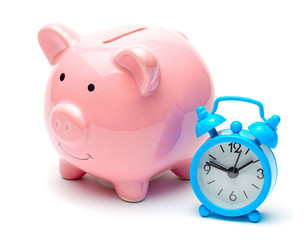 Time is money. Piggy bank and clock with an alarm clock. Isolated on a white background