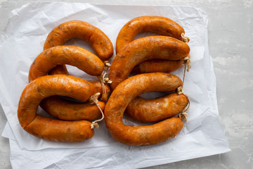 portuguese smoked sausages alheira on paper wooden background