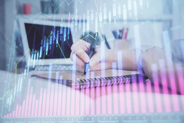 Financial graph displayed on woman's hand taking notes background. Concept of research. Double exposure