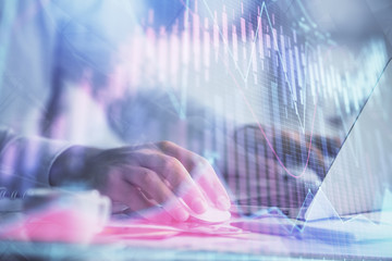 Double exposure of forex graph with man working on computer on background. Concept of market analysis.