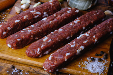 cooking pork sausages composition on a wooden background