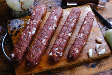 cooking pork sausages composition on a wooden background