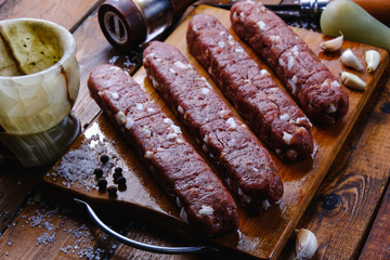 cooking pork sausages composition on a wooden background