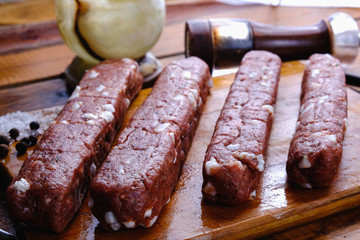 cooking pork sausages composition on a wooden background