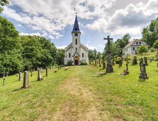 Fototapeta na wymiar Church and graveyard in Zadni Zvonkova, a border village