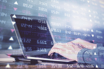 Double exposure of stock market graph with man working on laptop on background. Concept of financial analysis.