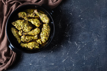 Pesto Chicken in a black dish, flat lay