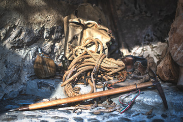 Old ice ax and crampons backpack outside an old alpine hut
