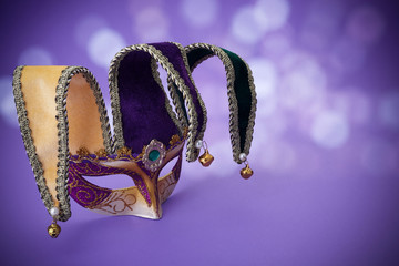 Traditional carnival mardi gras mask on table .Masquerade mask on glitter background. Mardi Gras