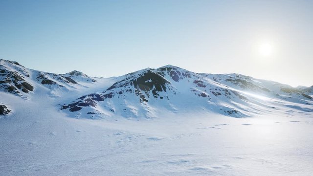 Aerial Landscape of snowy mountains and icy shores in Antarctica