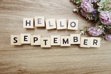 Hello September alphabet letters on wooden background