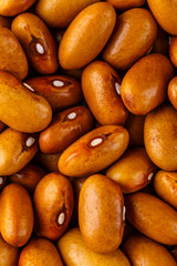 Beans of bean ( beans ). Background of many grains of dried beans. Brown beans texture. Food background. Close up.Vegetables for diet and healthy eating.Organic food. Background of brown bean.