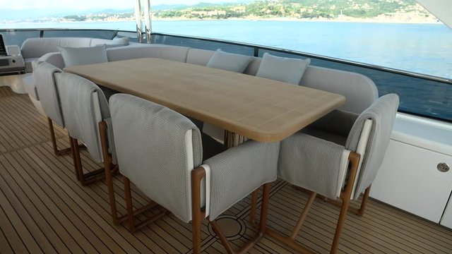 Dining area on the upper deck of a luxury yacht.