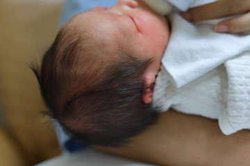 Obraz na płótnie Canvas closeup black hair of asian baby newborn