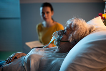 Woman assisting a senior patient at the hospital - Powered by Adobe