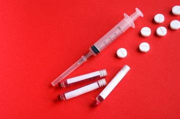 Vials with a cure for the disease, 3 ml, a plastic syringe with a needle and pills.
