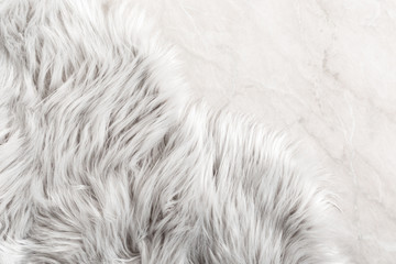 White fur for background or texture. Fuzzy white fur plaid. Shaggy blanket background. Fluffy fake textile fur. Flat lay, top view, copy space