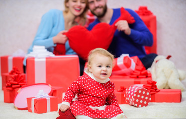 Obraz na płótnie Canvas She is the center of their universe. father, mother and doughter child. Shopping. Love and trust in family. Bearded man, woman with little girl. Happy family with gift box. Valentines day. Red boxes