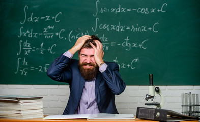 Teacher give up. Hate his job. Teacher mature man. Fed up. Man desperate teacher in classroom. No...