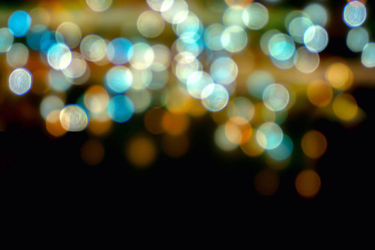 Abstract colorful bokeh and blurred reflection lighting on black background.