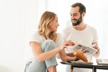 Positive loving couple indoors drinking coffee.