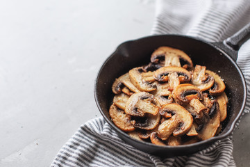 Delicious fried mushrooms with flat bread and herbs on the wooden table