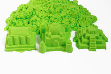 Kinetic sand of green color. Fine motor skills, creativity, games for children, entertainment