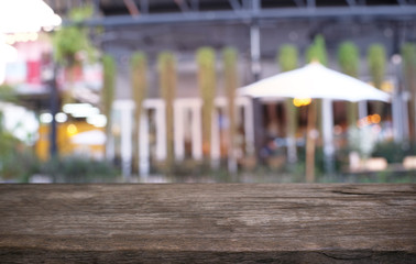 Empty dark wooden table in front of abstract blurred bokeh background of restaurant . can be used for display or montage your products.Mock up for space.