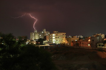 Naklejka na ściany i meble Lightning above city scape. Maharashtra, India.
