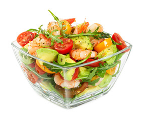 Salad with avocado, shrimp, fresh cherry tomatoes and arugula in glass bowl isolated on white