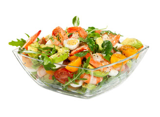 Salad with avocado, shrimp, fresh cherry tomatoes and arugula in glass bowl