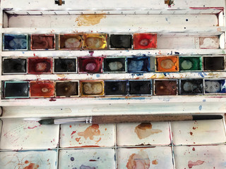 Paintbrush artist palette and multi colored gouache
