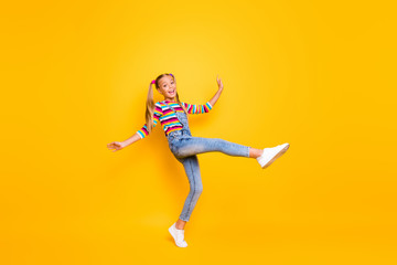 Fototapeta na wymiar Full length photo of candid funny kid enjoy spring autumn rest relax holidays raise her legs up wear casual style pullover footwear isolated over shine color background