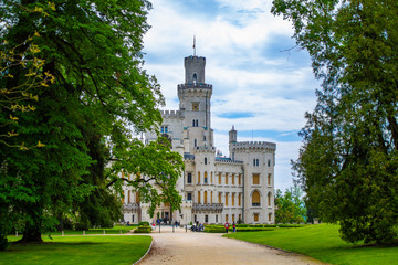 Obraz premium Facade of Hluboka Castle (Hluboka nad Vltavou Castle), also called The State Chateau of Hluboka, between trees from Zamecky Park, in South Bohemia region, Czech Republic