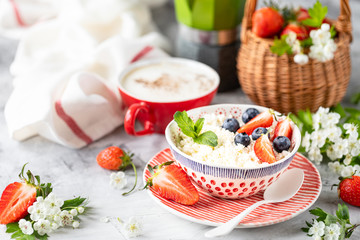 Cottage cheese with berries, jam, fresh strawberries and a cup of coffee with cream for breakfast. The recipe for the holiday Valentine's Day. Copy space