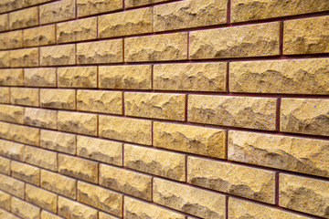 Yellow decorative brick wall in angle projection view with copy space.