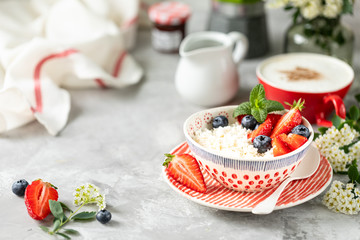 Cottage cheese with berries, jam, fresh strawberries and a cup of coffee with cream for breakfast. The recipe for the holiday Valentine's Day. Copy space