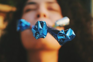 Girl blowing the party poppers