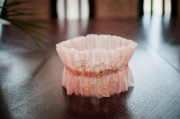 Peach color garter lying on the wooden table